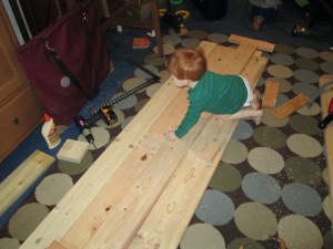 Josh "helps" me measure and cut the side rails on his big brother's bed.